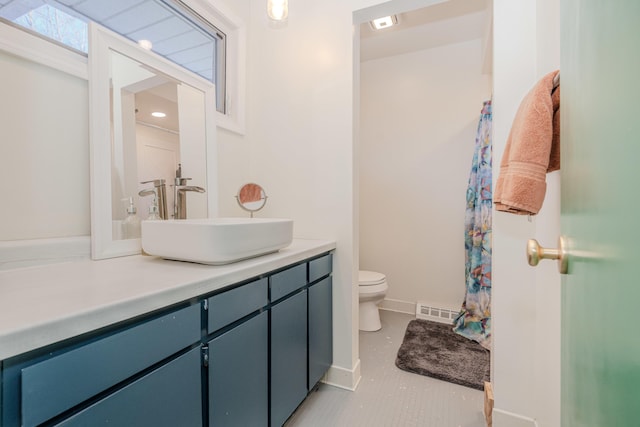 bathroom with vanity, toilet, and tile patterned flooring