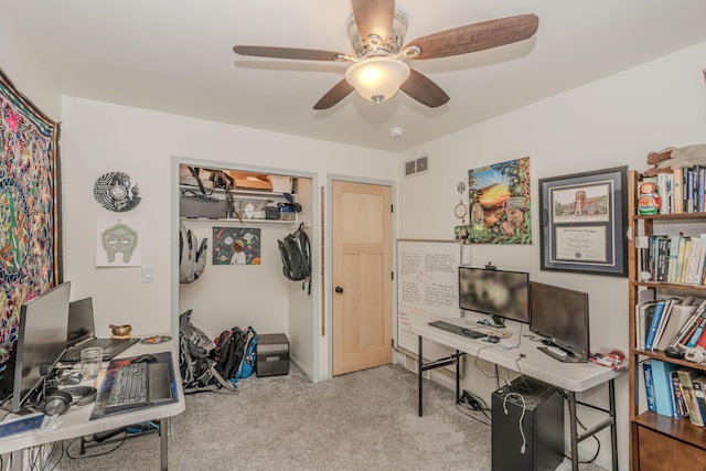 carpeted office space featuring ceiling fan