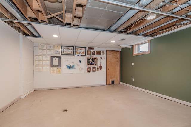 basement featuring a drop ceiling