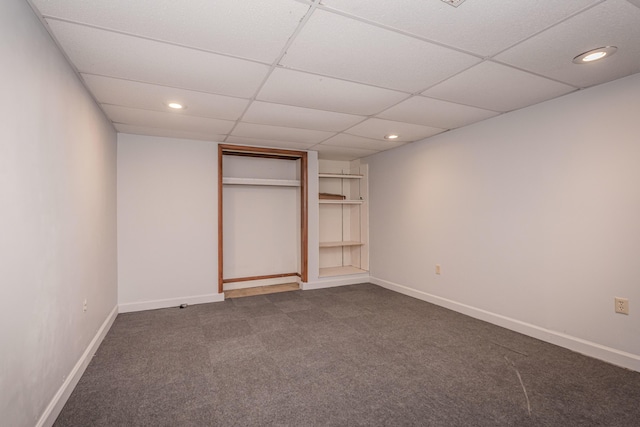 unfurnished bedroom with a closet and dark colored carpet