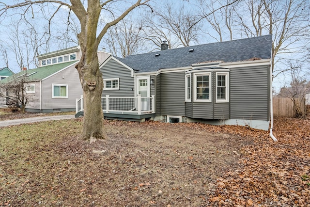 rear view of house featuring a wooden deck