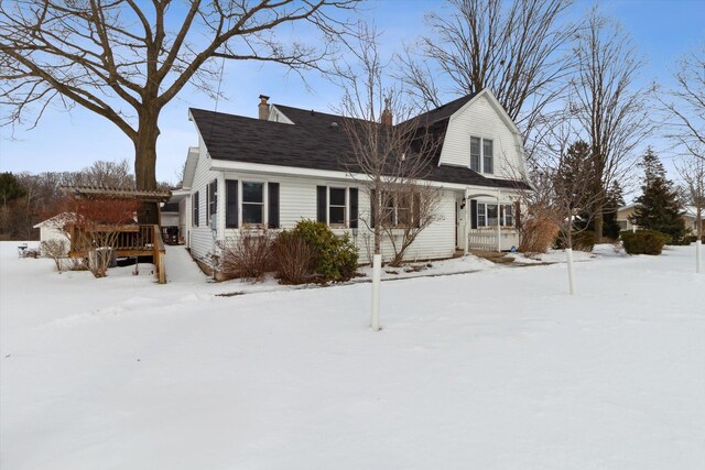 view of snow covered back of property