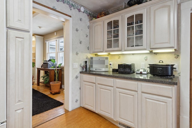 kitchen with white cabinets and light hardwood / wood-style flooring