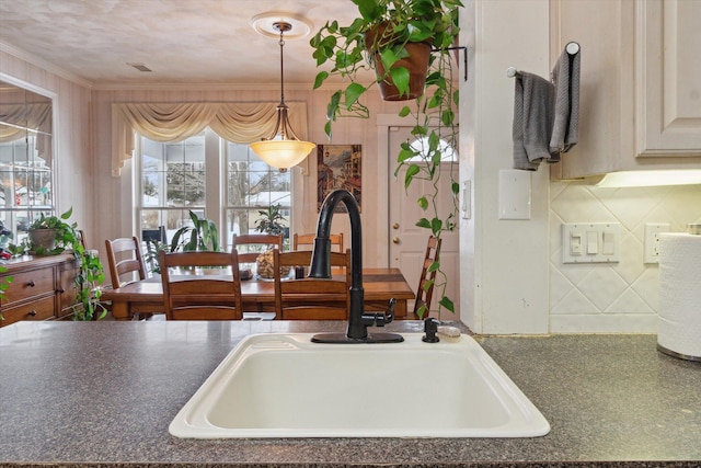 kitchen with sink and ornamental molding