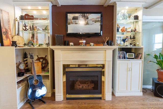 bar featuring beam ceiling and light hardwood / wood-style flooring