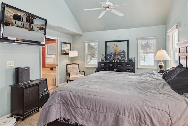 bedroom featuring ensuite bathroom, lofted ceiling, light colored carpet, and ceiling fan