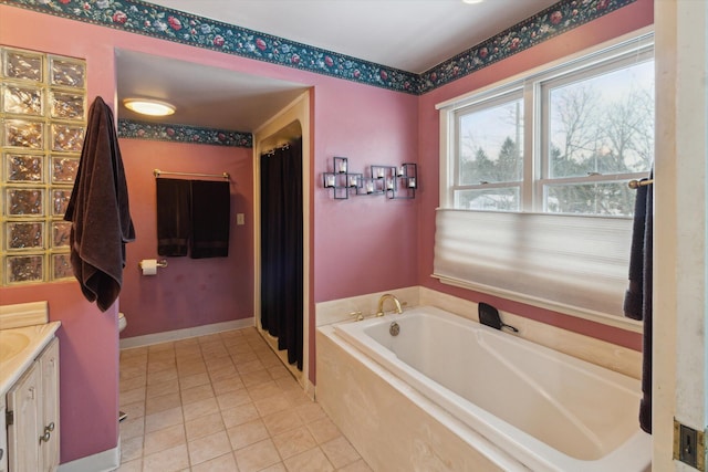 bathroom featuring tile patterned floors, a bathing tub, and vanity