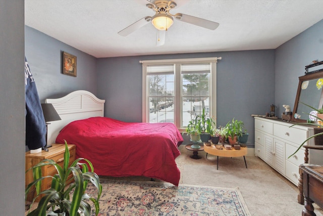 bedroom with carpet floors, a textured ceiling, and ceiling fan