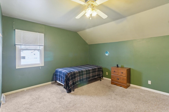 bedroom with ceiling fan, carpet floors, and vaulted ceiling