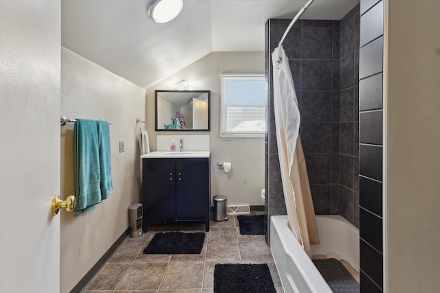 bathroom with lofted ceiling, vanity, and shower / tub combo