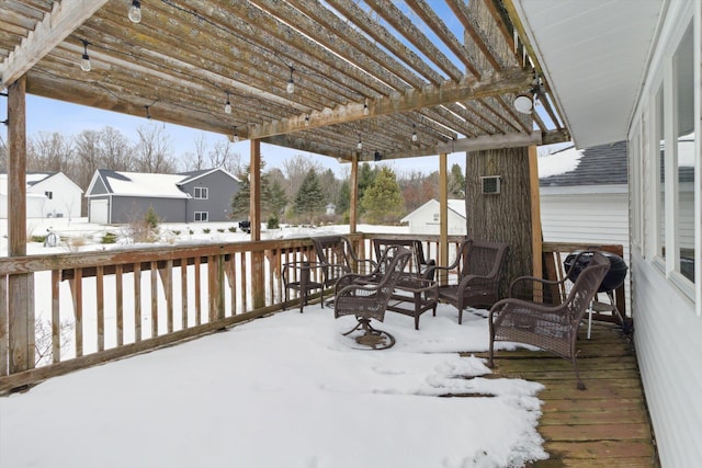 snow covered deck with a pergola