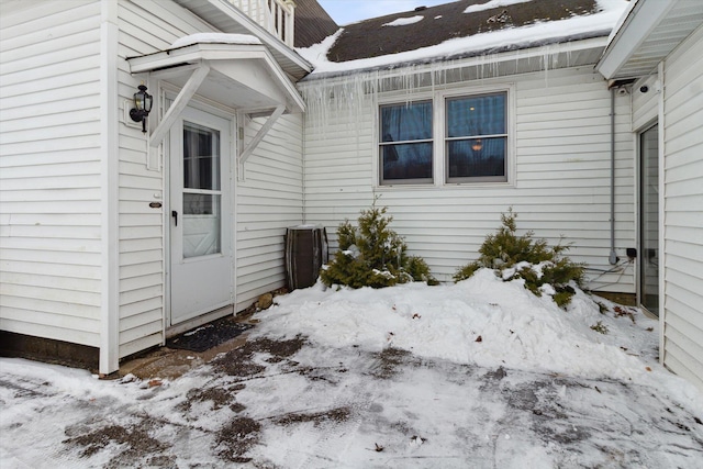 view of snow covered property entrance