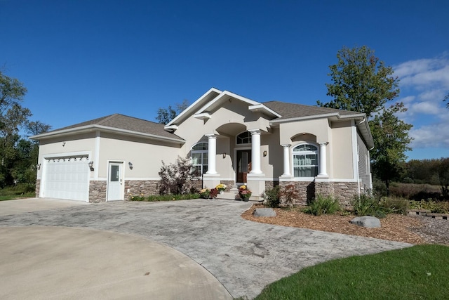 view of front facade with stucco siding, a garage, stone siding, concrete driveway, and a shingled roof