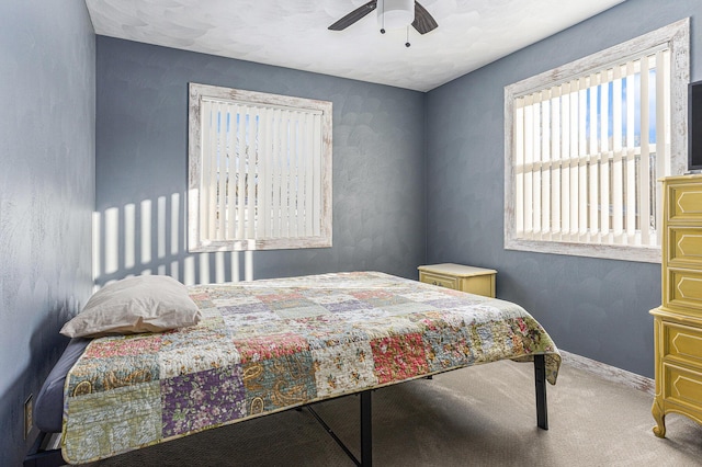 bedroom featuring ceiling fan and carpet