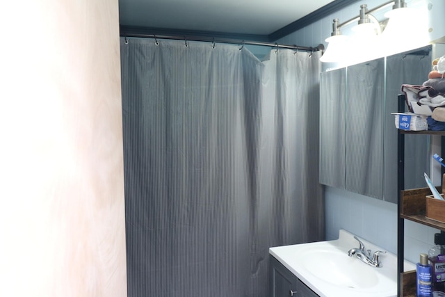 bathroom with vanity and ornamental molding