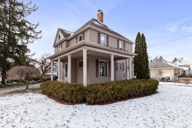 view of snow covered exterior featuring covered porch