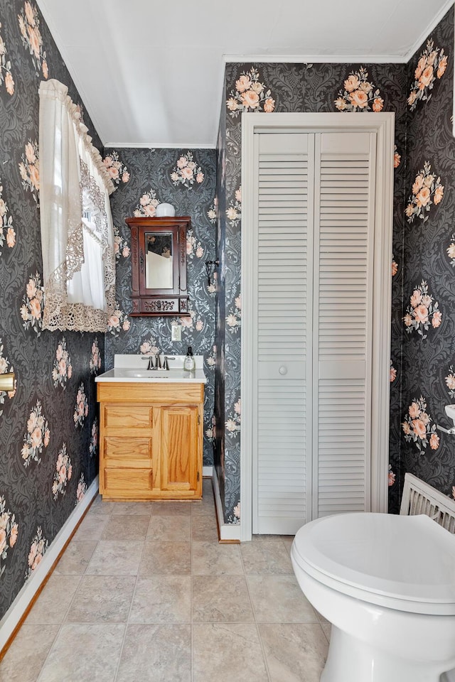 bathroom with tile patterned flooring, vanity, and crown molding