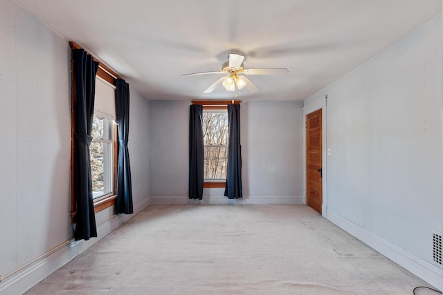 empty room with light colored carpet and ceiling fan