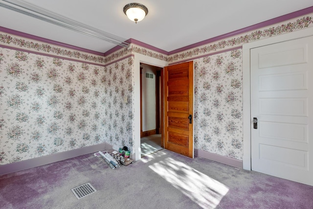 carpeted empty room featuring ornamental molding