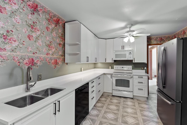 kitchen featuring ceiling fan, sink, white cabinets, and white appliances