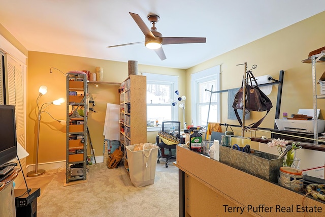 home office featuring light colored carpet and ceiling fan