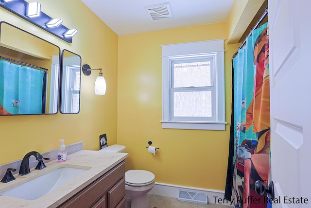 bathroom featuring vanity, curtained shower, tile patterned floors, and toilet