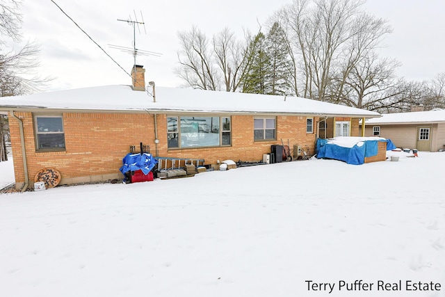 view of snow covered rear of property