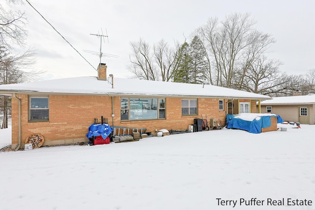 view of snow covered rear of property