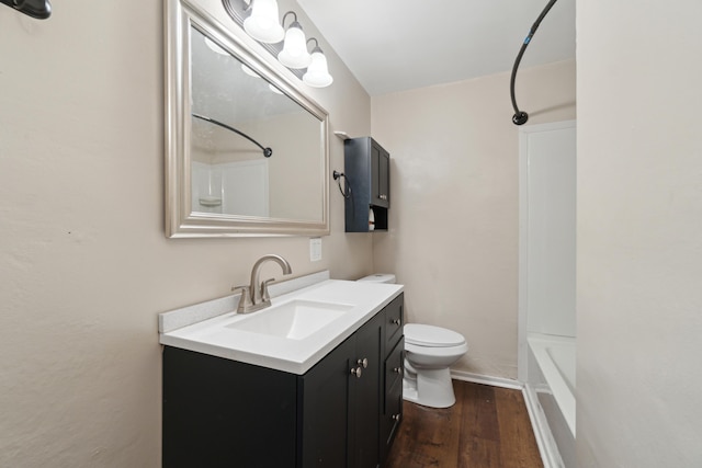 full bathroom featuring shower / bath combination, vanity, hardwood / wood-style floors, and toilet