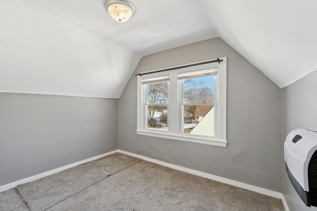 bonus room with heating unit, carpet floors, and vaulted ceiling