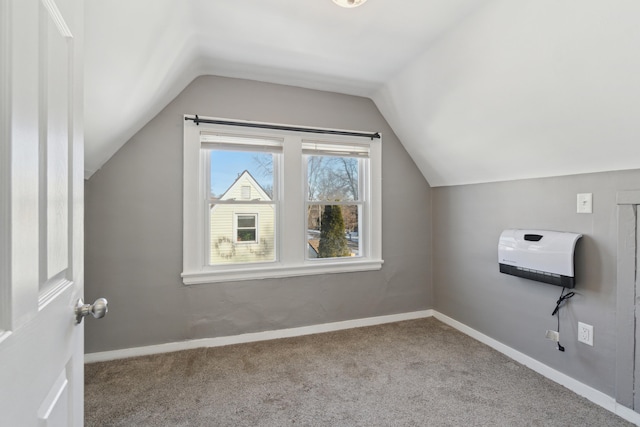 bonus room featuring vaulted ceiling and light colored carpet