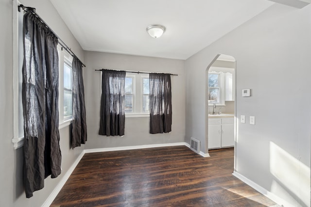 empty room with dark hardwood / wood-style flooring and sink