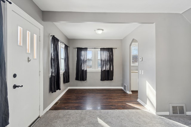 carpeted entryway featuring vaulted ceiling