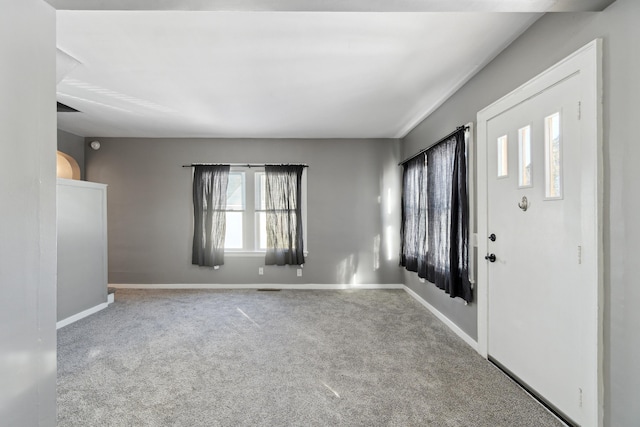 foyer featuring light colored carpet