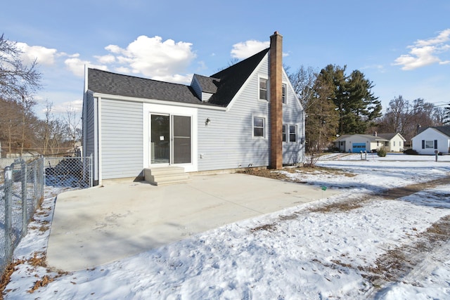 snow covered property with a patio