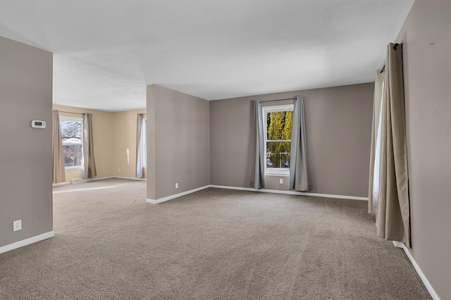 carpeted empty room with a healthy amount of sunlight