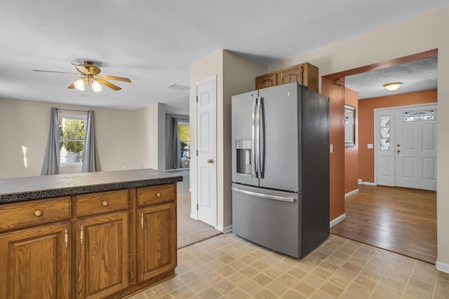 kitchen with ceiling fan and stainless steel fridge with ice dispenser