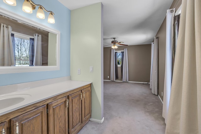 bathroom with vanity, a healthy amount of sunlight, and ceiling fan