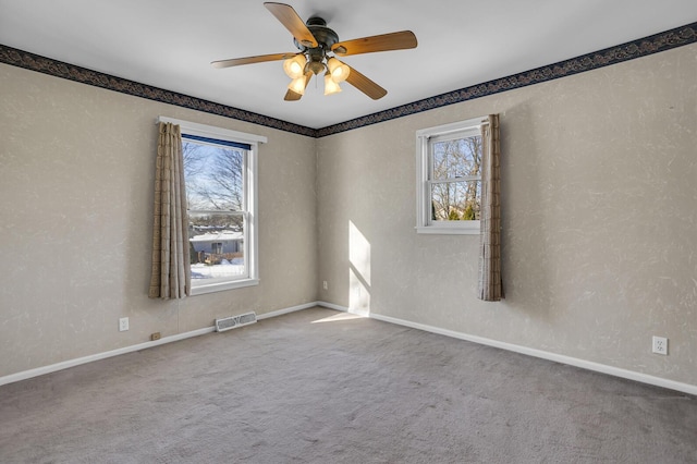 spare room with carpet flooring and ceiling fan