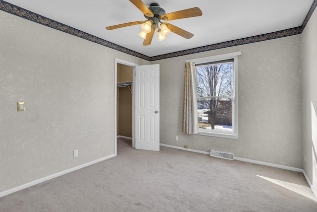 unfurnished bedroom with light colored carpet, ceiling fan, and a closet