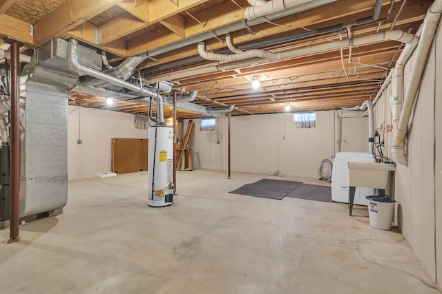 basement featuring heating unit, sink, washer / dryer, and gas water heater