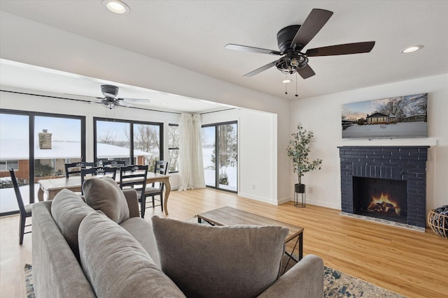 24112 N Shore Dr, Edwardsburg, MI 49112 - living area with light wood finished floors, baseboards, a fireplace, ceiling fan, and recessed lighting