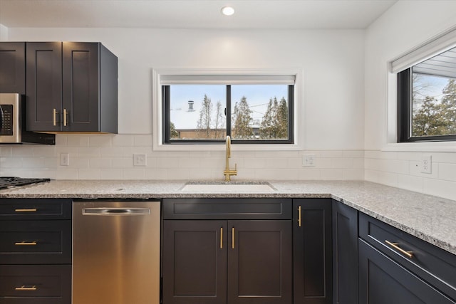 24112 N Shore Dr, Edwardsburg, MI 49112 - kitchen with recessed lighting, tasteful backsplash, a sink, and stainless steel appliances