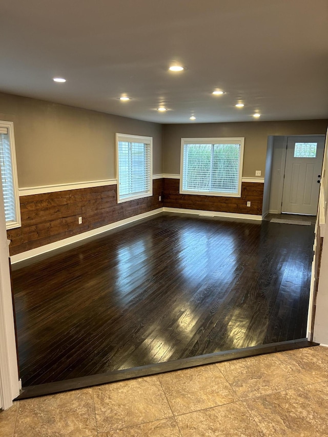 unfurnished room with wooden walls