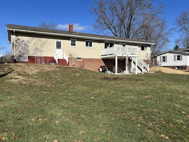 back of house with a lawn and a deck