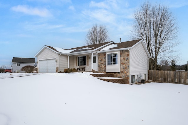 ranch-style house with a garage and central air condition unit