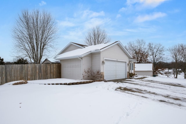 view of snow covered exterior with a garage