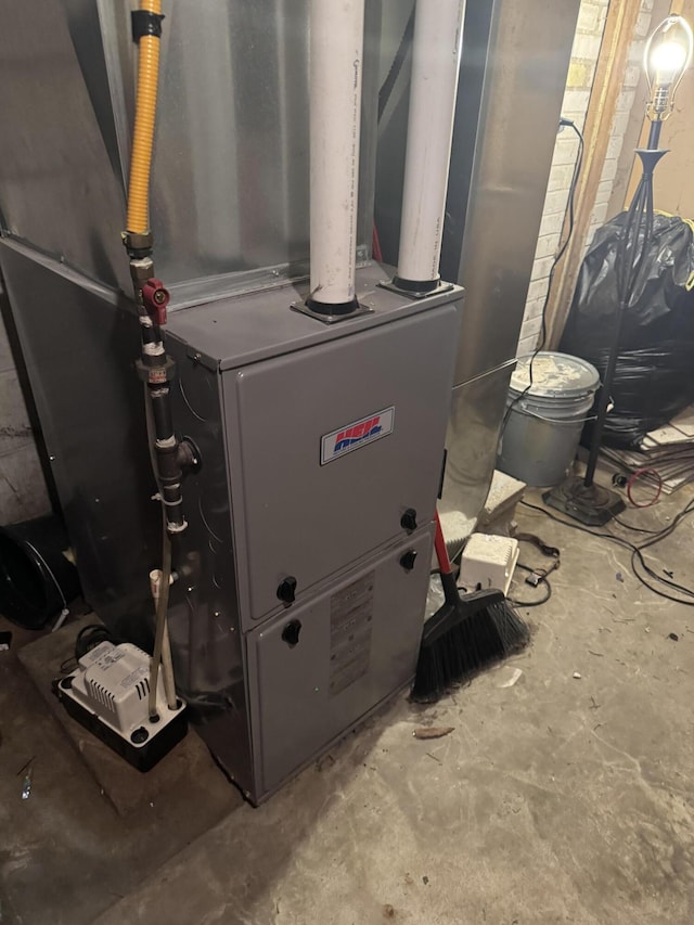 utility room featuring heating unit