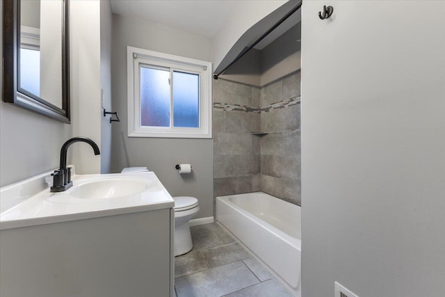 full bathroom featuring tile patterned floors, toilet, tiled shower / bath combo, and vanity