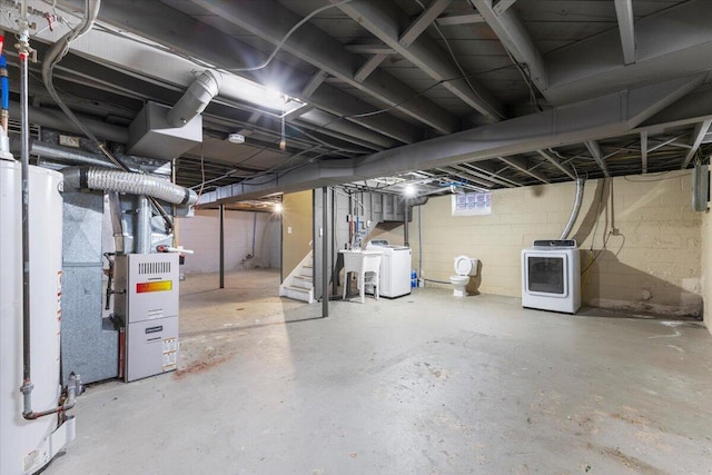 basement with heating unit, washer / clothes dryer, and water heater